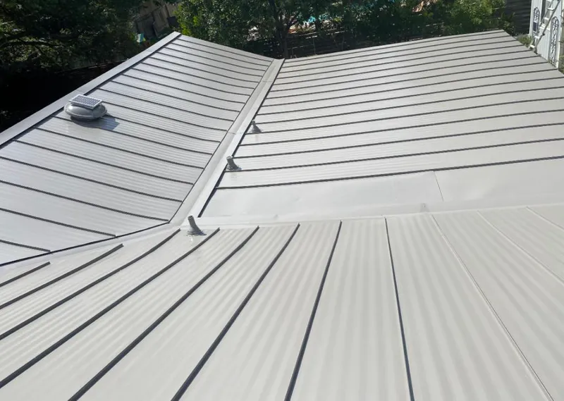 Solar attic fan installed on a metal roof for Roof Ventilation in Fairfax